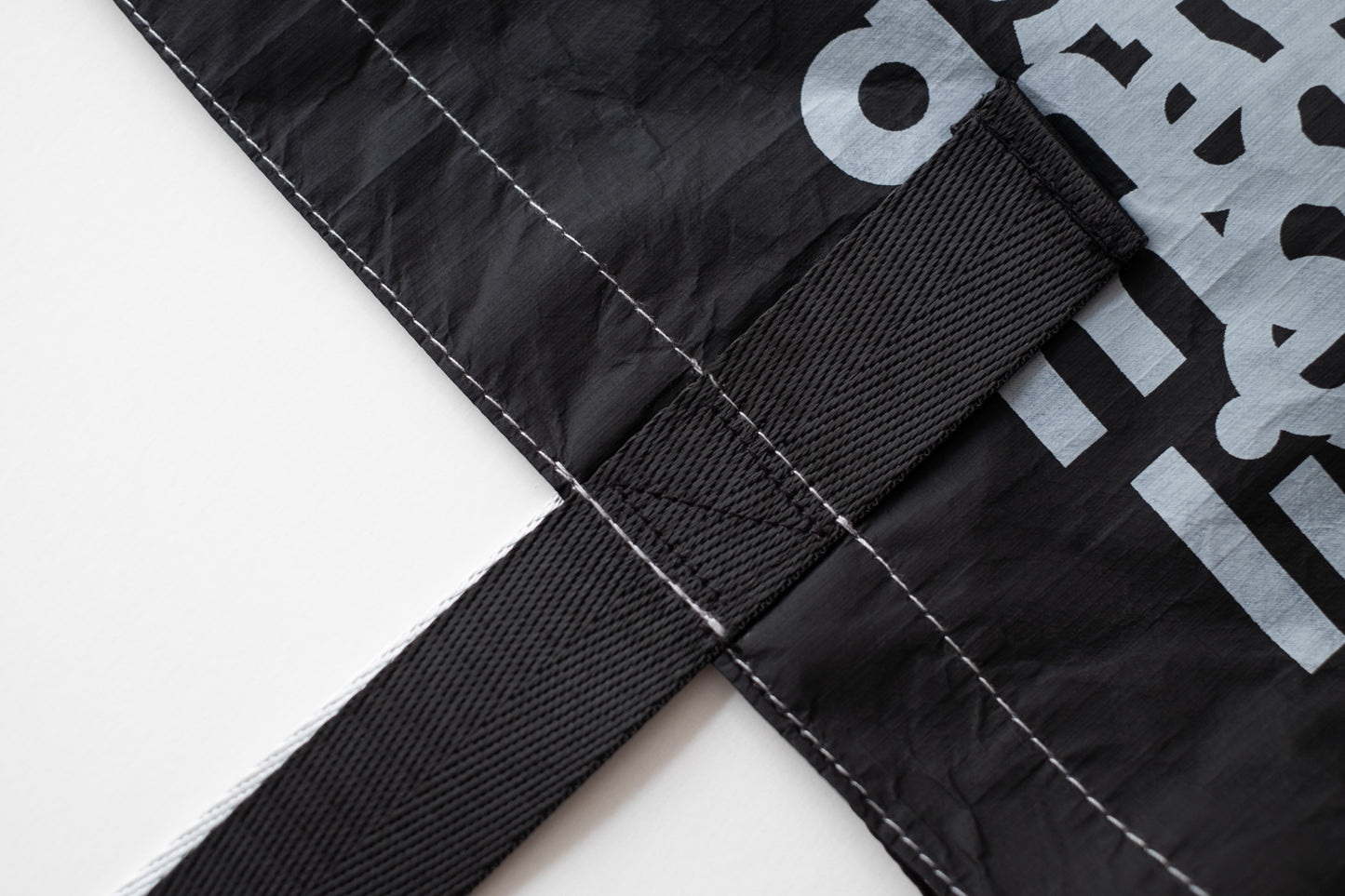 Close-up of the D-ja Tote Bag's handle stitching, showcasing the high-quality construction detail, built for longevity and everyday outfit.