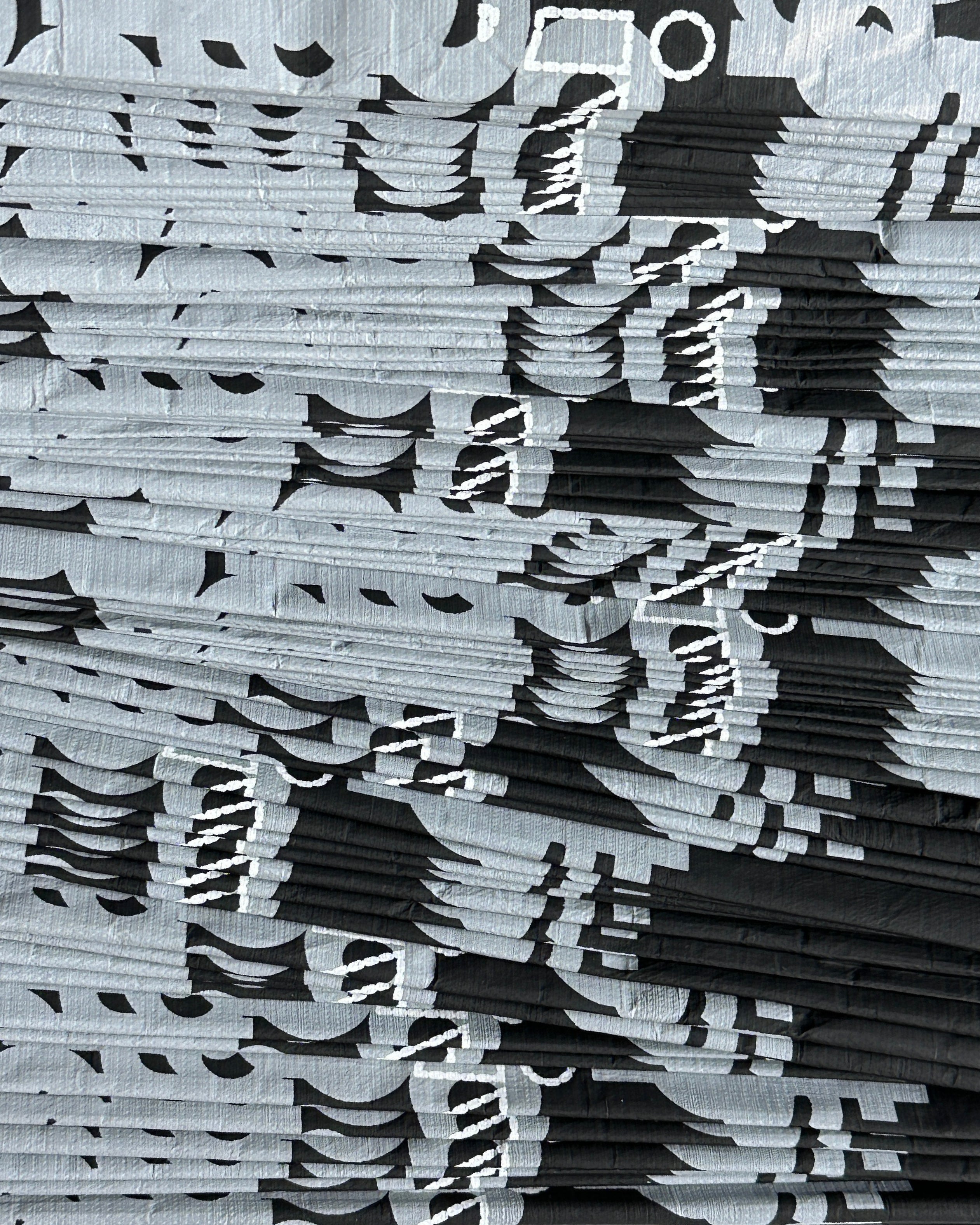 A stack of D-ja Tote Bags, showcasing their lightweight paper-like texture and minimal yet functional design.