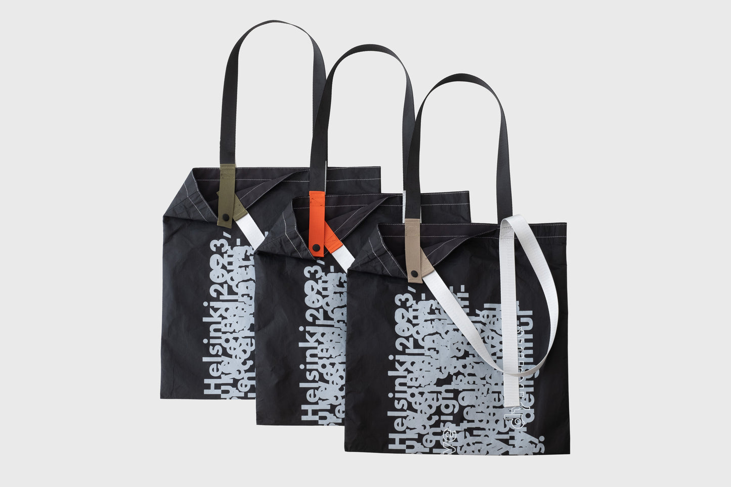 Three D-ja Tote Bag Plus in moss, persimmon, and sand colour options, highlighting the inner strap colours that add a playful and personal touch.