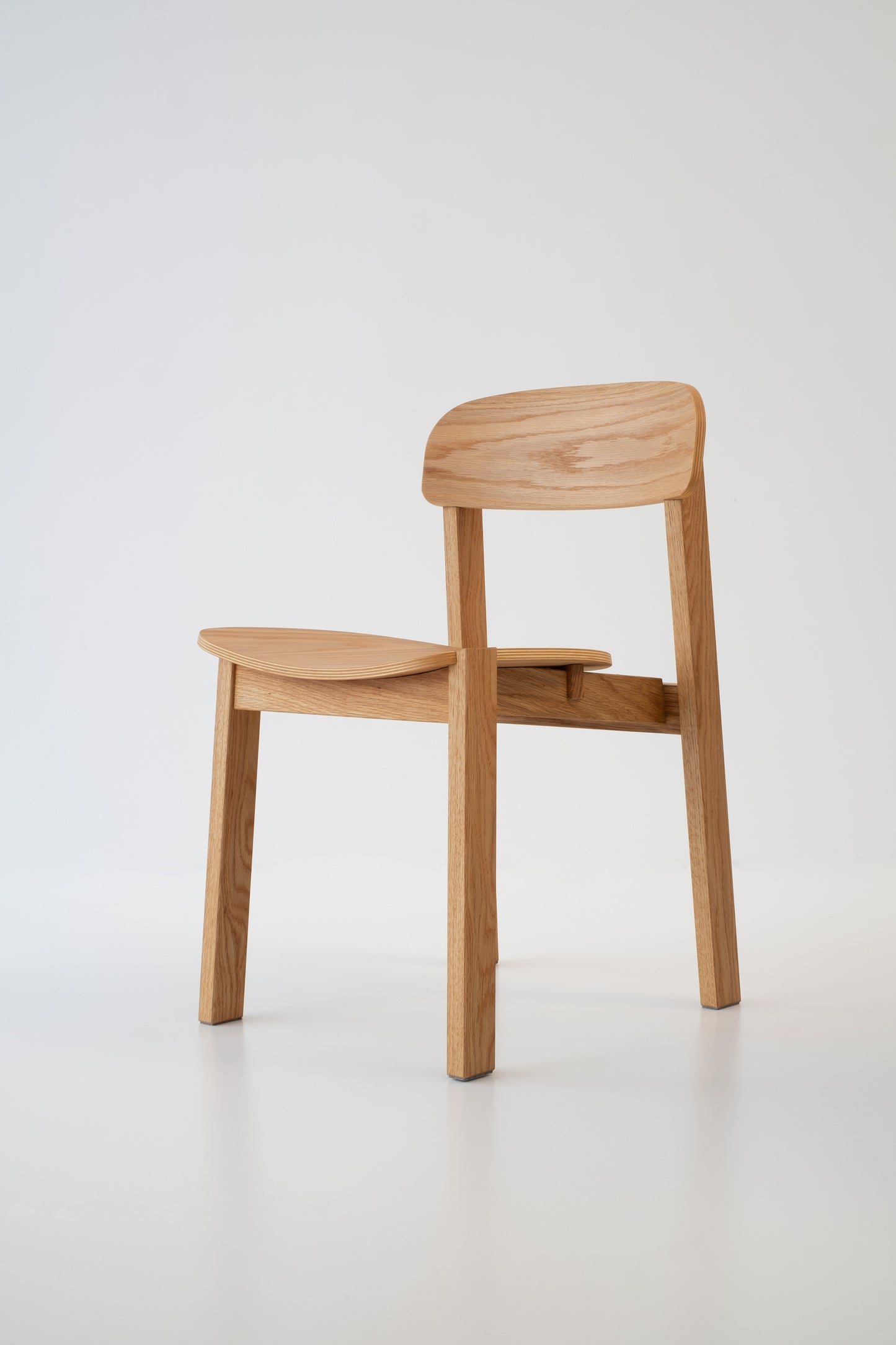 Front view of Siirto Chair - handcrafted wooden dining chair with ergonomic comfort and asymmetrical design.
