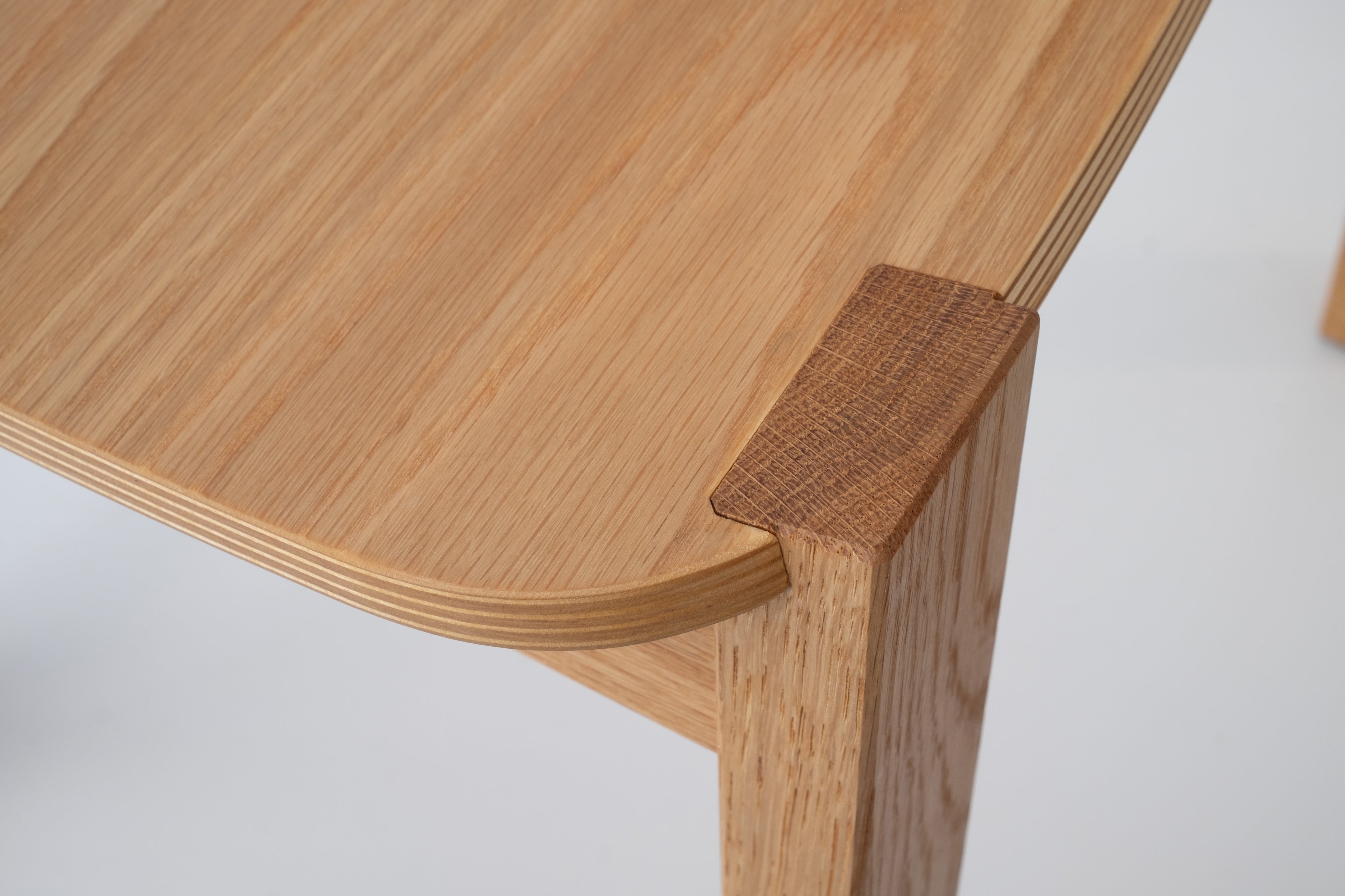 Close-up of the handcrafted joints and wood finish on the Siirto Chair, showcasing expert craftsmanship.