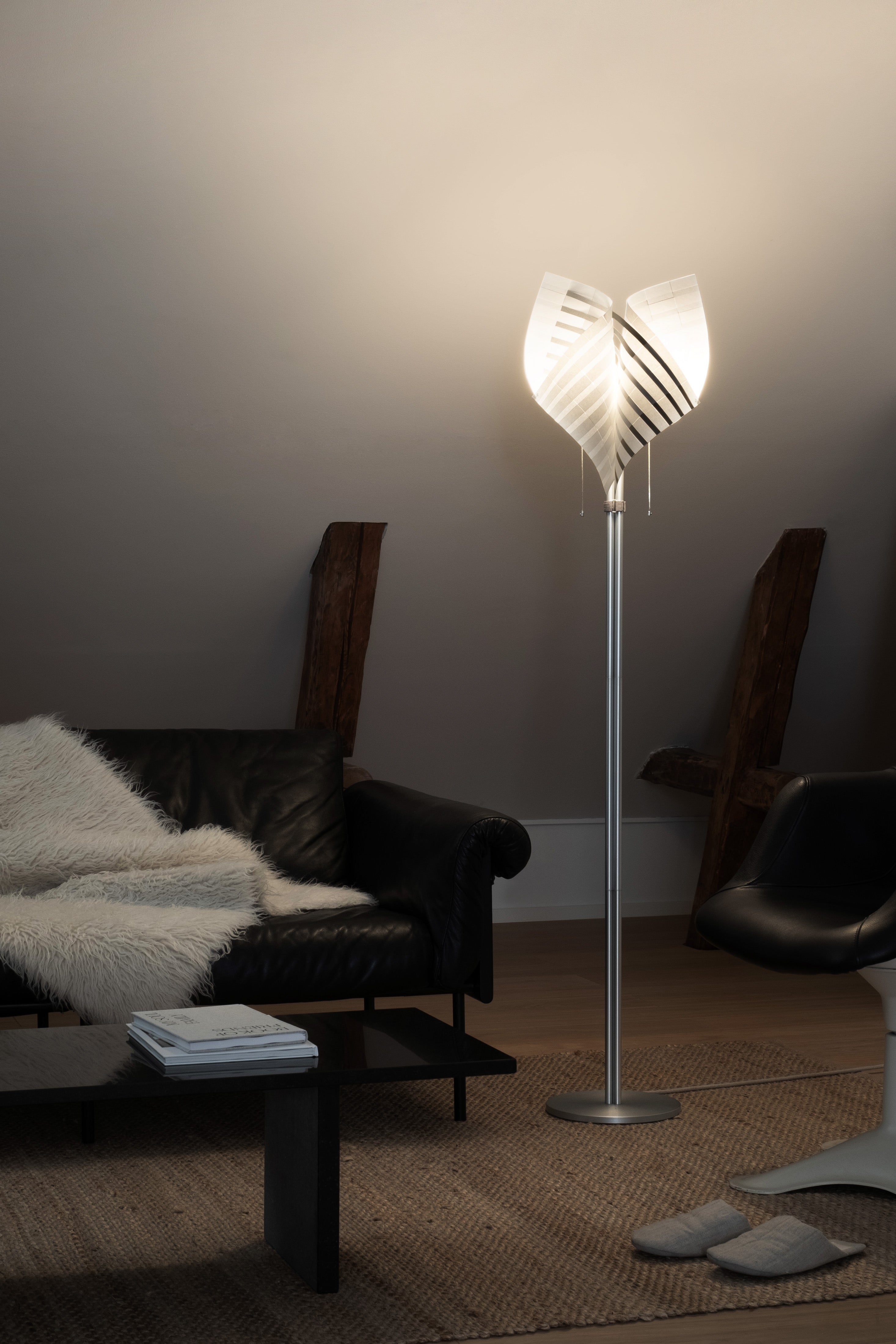 Close-up of TEX001 floor lamp details, highlighting the delicate pull chain switch, translucent lamp holder, and sculptural handwoven paper lampshade.