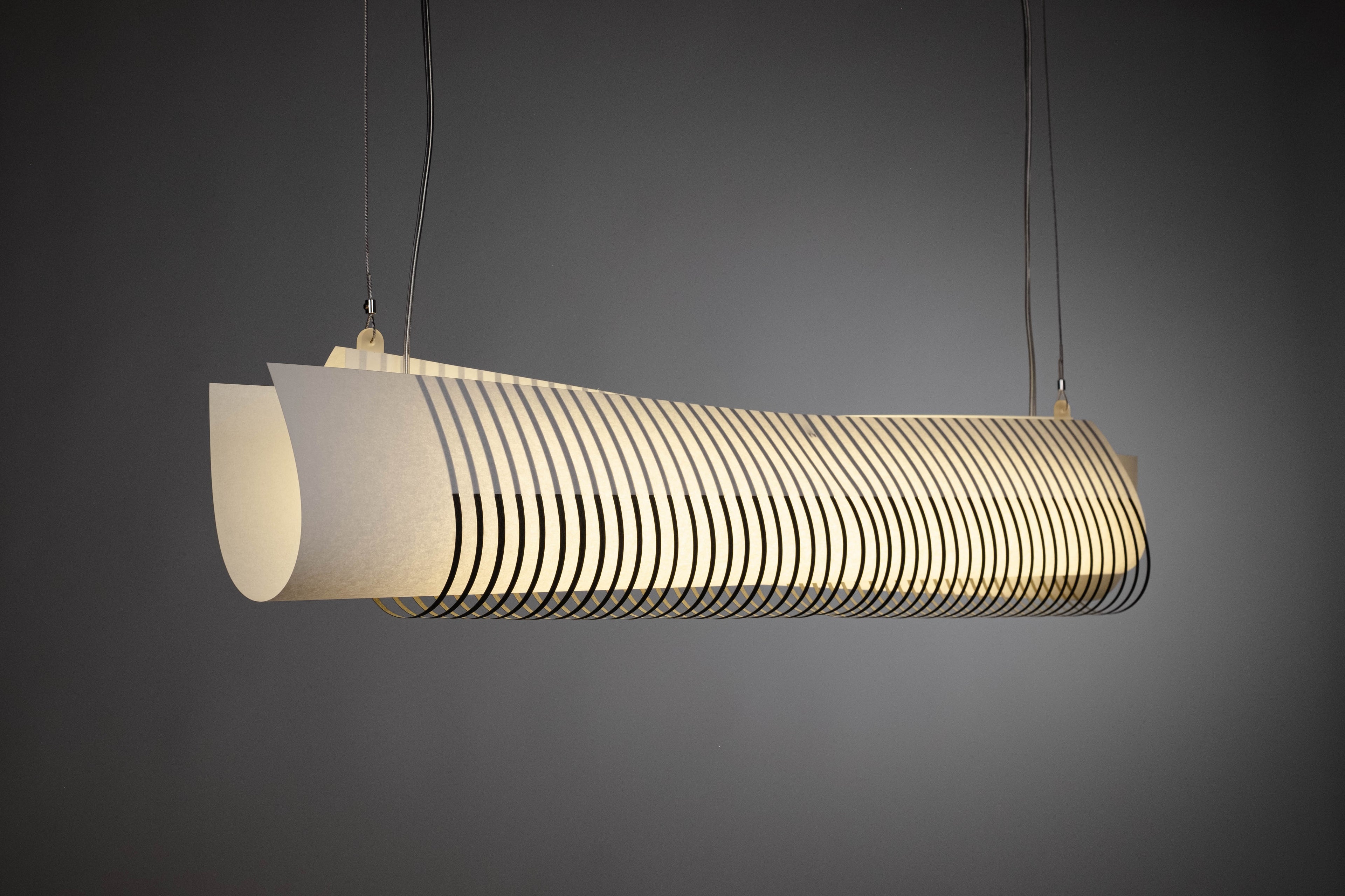 TEX002 pendant lamp glowing from an angled perspective, showcasing its floating architectural design, perfect for modern dining rooms, offices, and hotels.