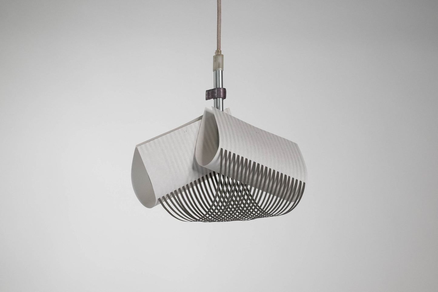 TEX003 pendant lamp with its light off, highlighting the structured, geometric surface of the handwoven paper lampshade and the refined craftsmanship.