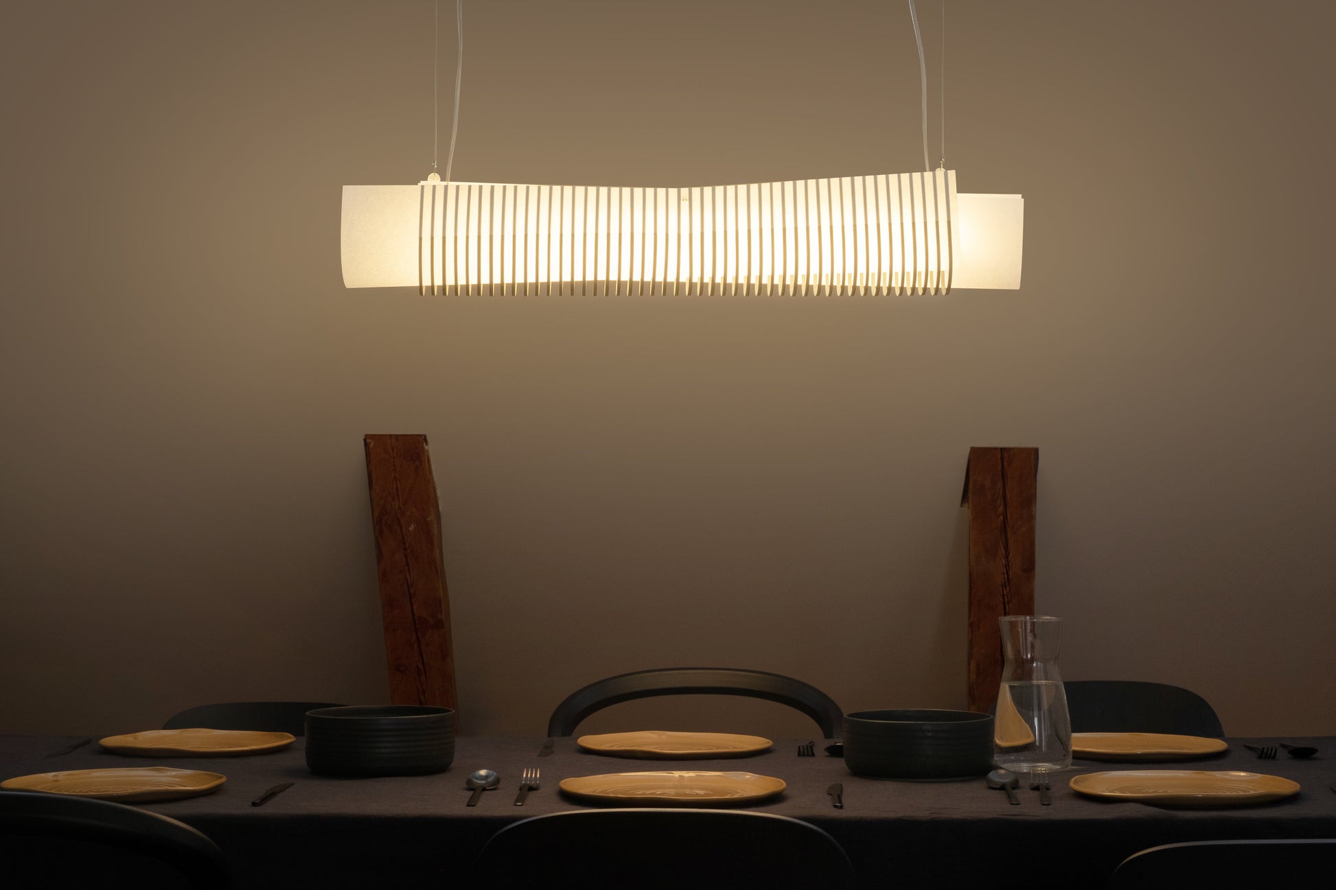 TEX002 pendant lamp hanging above a long dining table, enhancing the Nordic contemporary aesthetic with timeless elegance and warm ambient lighting.